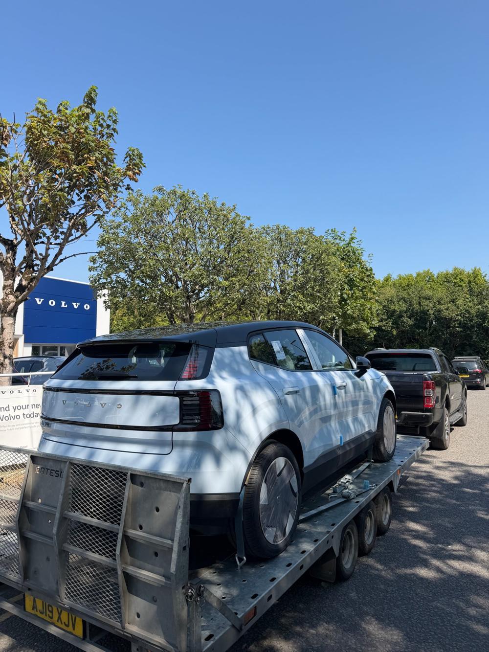 New electric car delivered from a dealership on a DM Transporter trailer